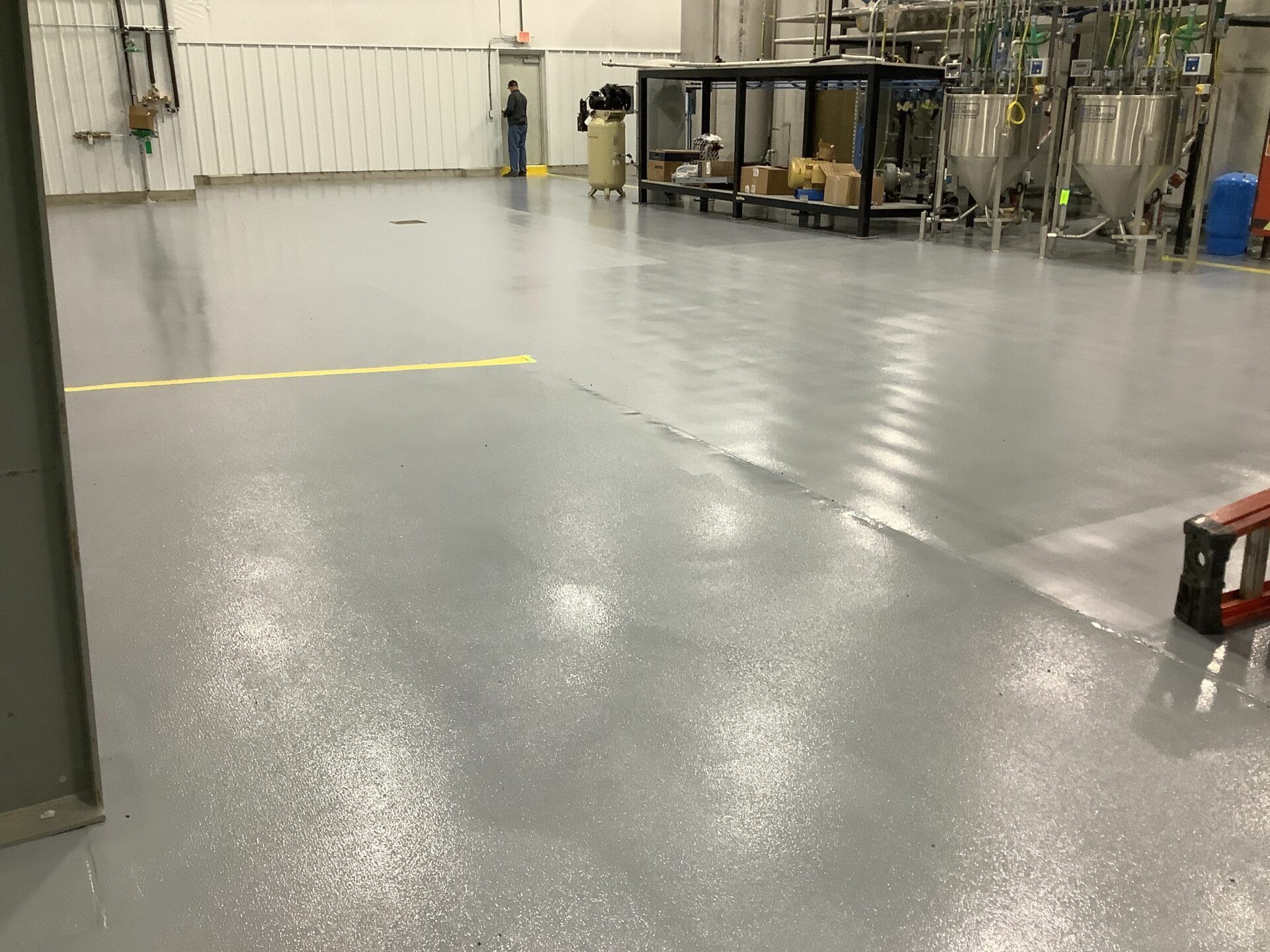 Industrial-grade epoxy flooring in a new fertilizer plant maintenance area.